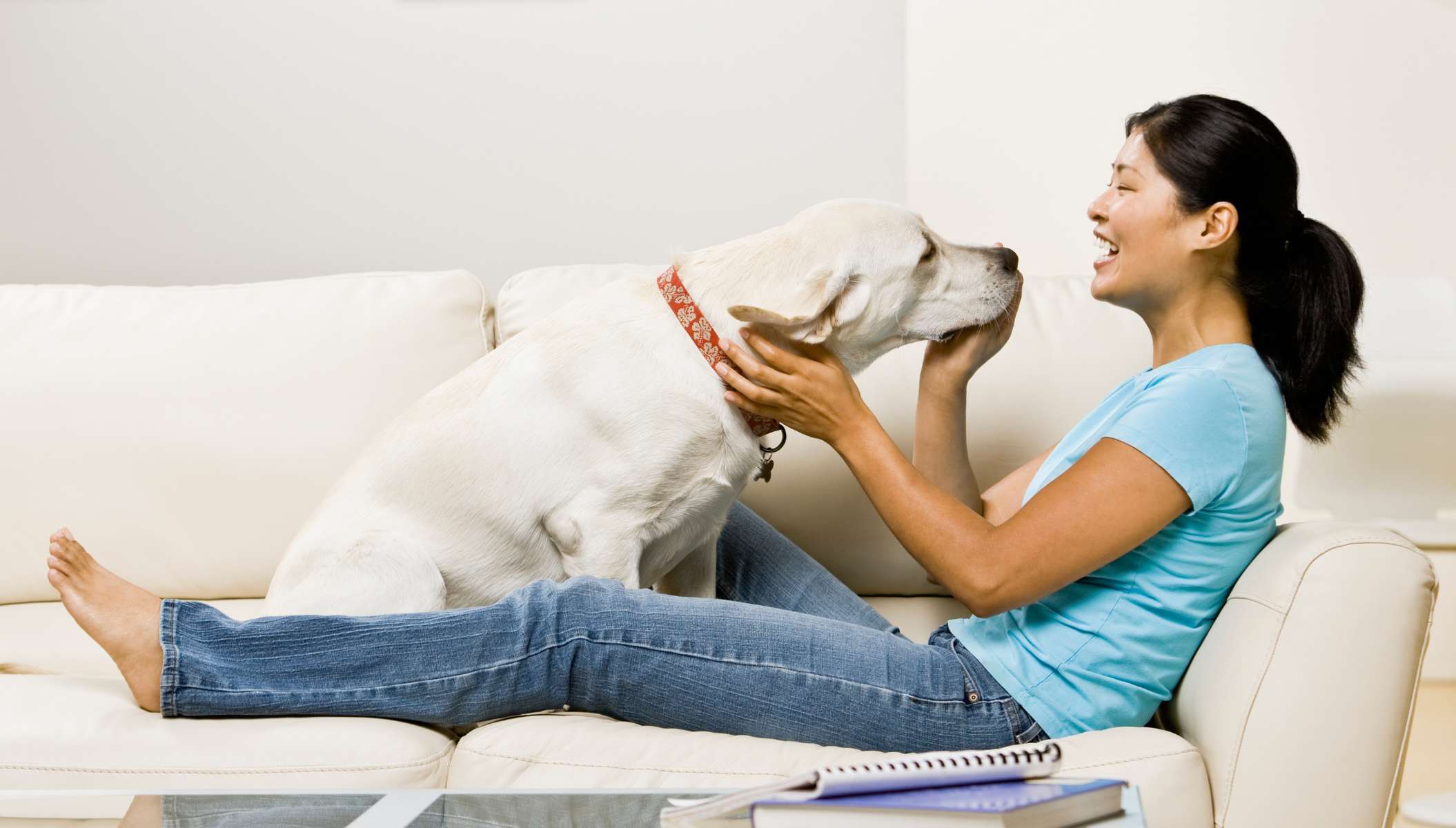 Woman and Pet Enjoy Clean Air from AC Unit at Home
