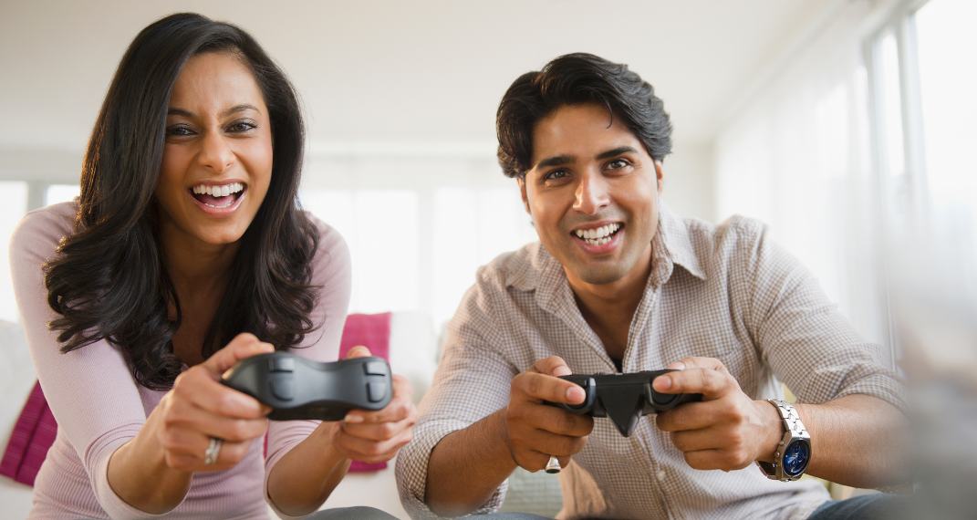 Couple playing video games in perfect temperature at home